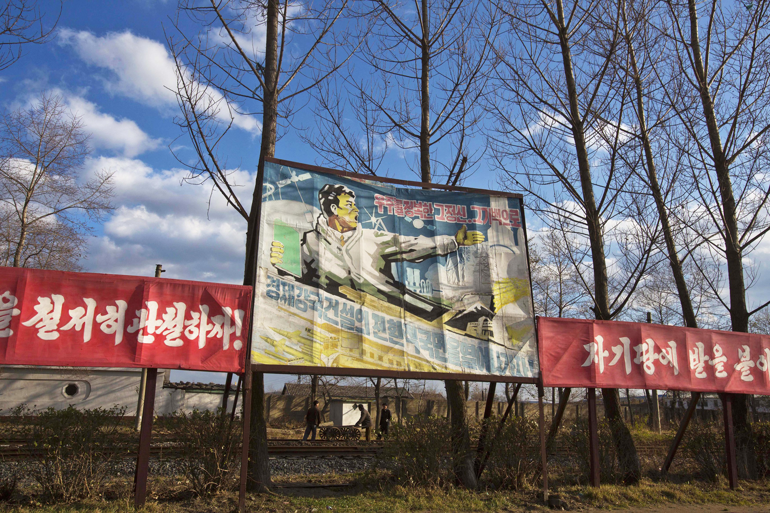 A propaganda billboard, which reads "Let's work toward opening a new phase for constructing a powerful economy with the mentality and spirit to conquer the universe," stands in Rajin, North Korea, inside the Rason Special Economic Zone. In 2013, North Korea announced plans to create economic zones in every province.  Photo: AP