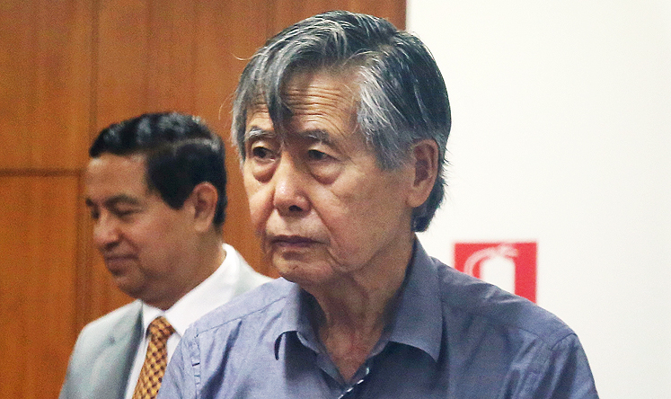 Jailed former President Alberto Fujimori enters the courtroom at a police base in Lima. Photo: AP
