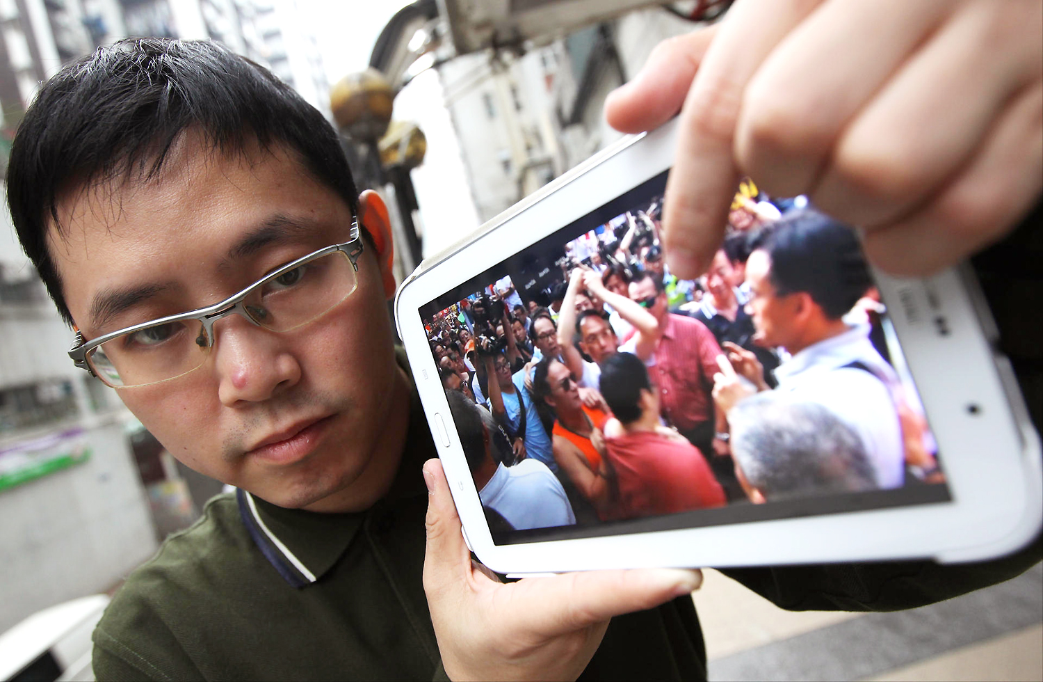 Simon Wan shows a video of the 'attack'. Photo: Nora Tam