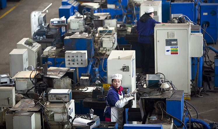 An employee works on a production line in Hangzhou. Photo: Reuters