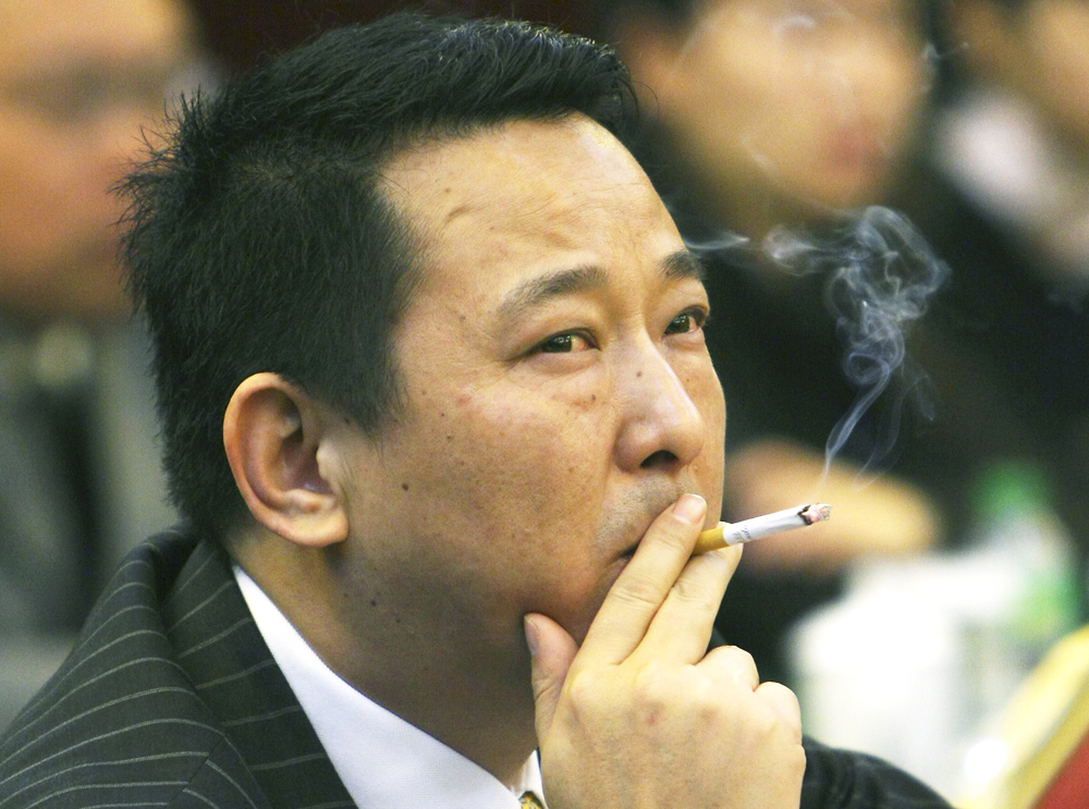 Liu Han, former chairman the Sichuan Hanlong mining group, smokes during a conference in Mianyang, Sichuan, in 2008. Photo: Reuters