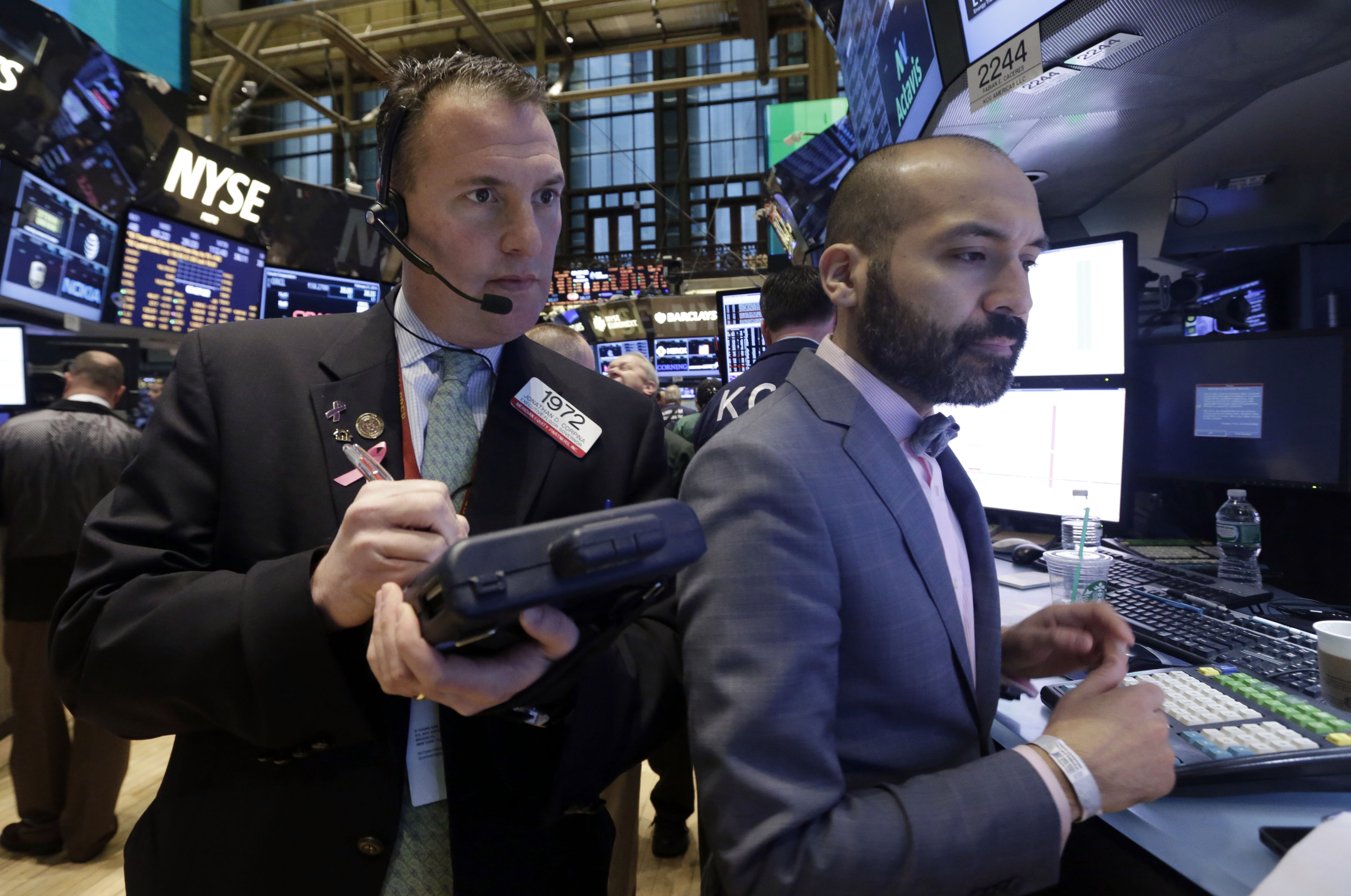Traders work on the floor of the New York Stock Exchange on Friday. Photo: AP