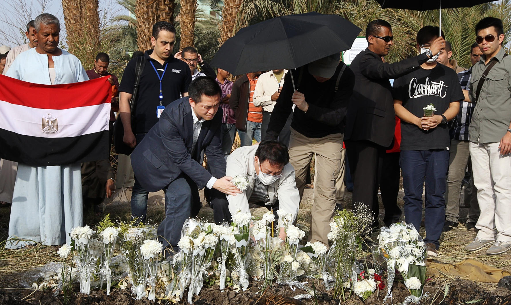 Family members of the victims attend a mourning ceremony at the crash site. Photo: Sam Tsang
