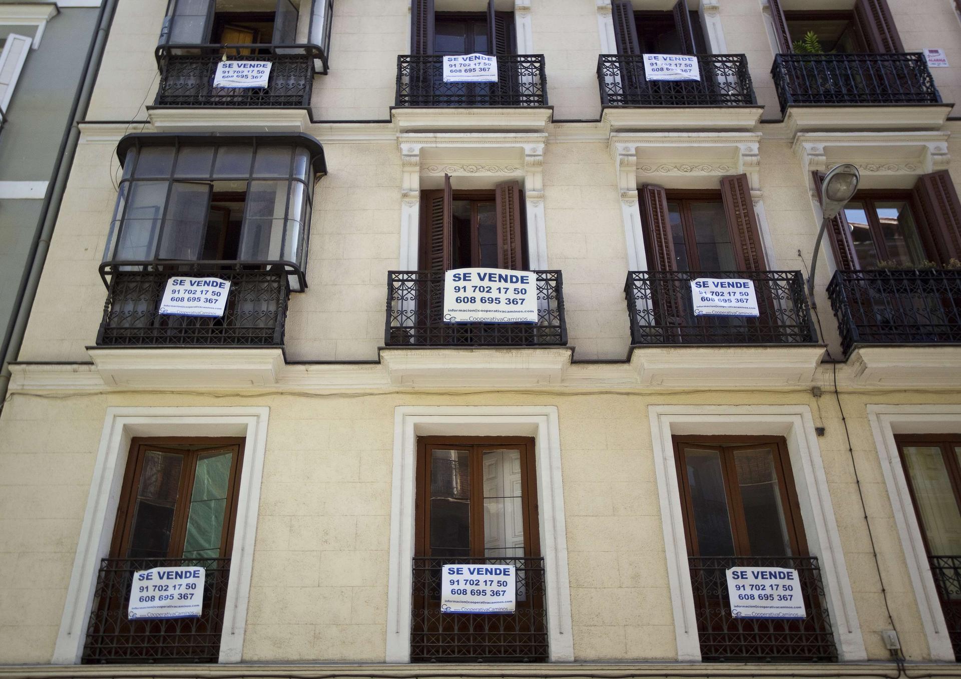 "For Sale" signs hang from balconies in Madrid. Photo: Reuters