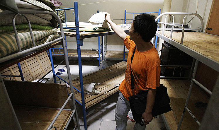 Human rights activist Liu Dejun inspects a "black jail" in Beijing. Photo: AP
