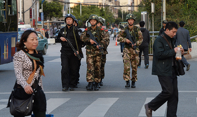 Chinese police and paramilitary soldiers patrol the streets after the attack at the main train station in Kunming, Yunnan province. Photo: AFP 