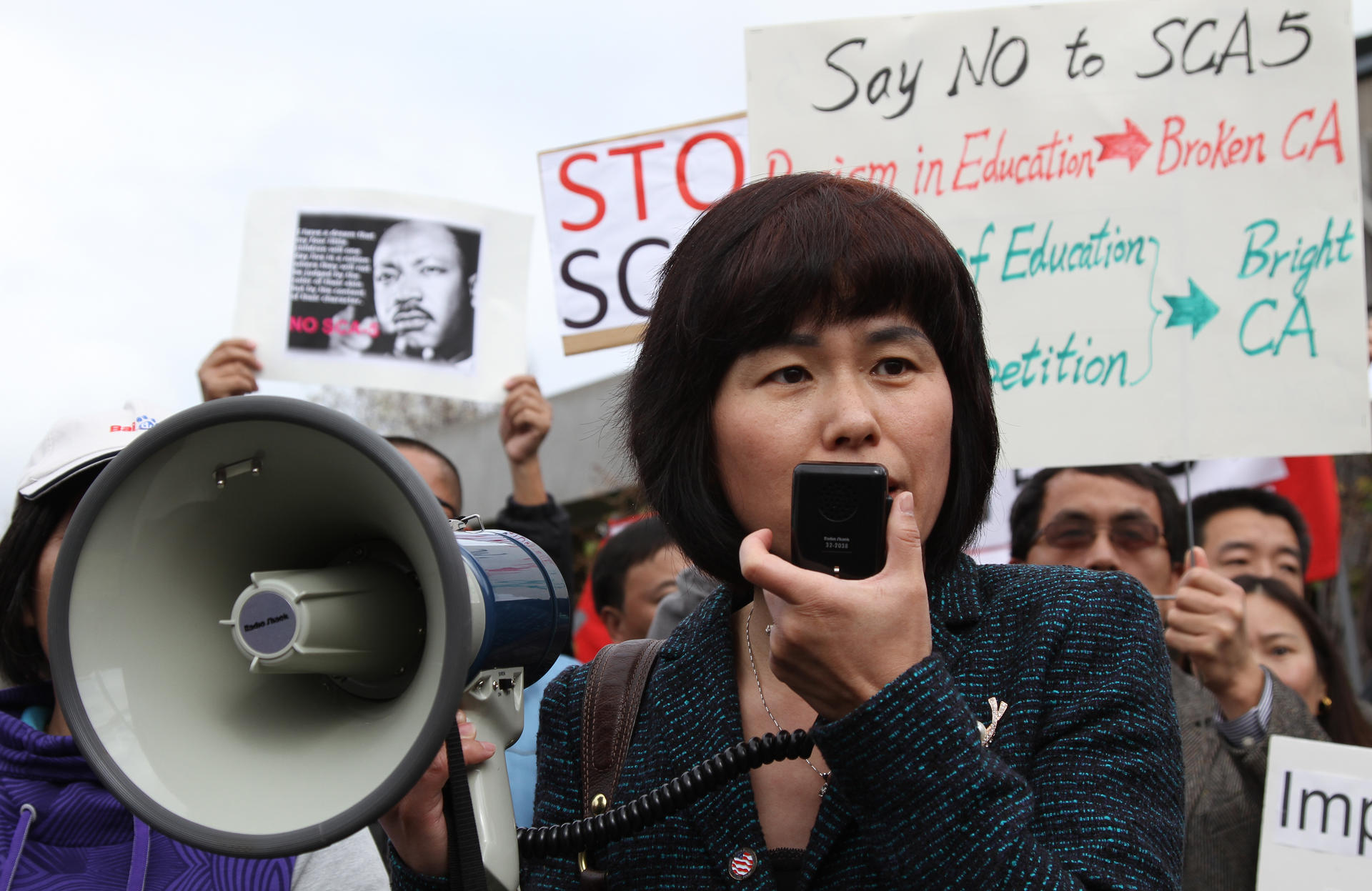 A community leader speaks to the crowd at a rally against the proposed college admissions amendment outside the town hall in Cupertino, California. Photo: Guisel Contreras