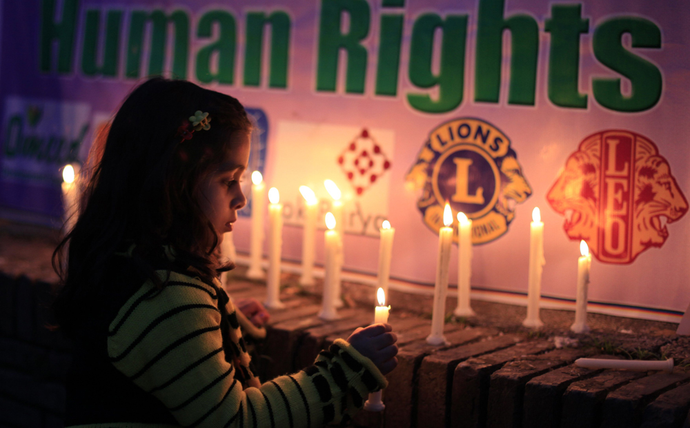 A girl lights candles during a rally to commemorate International Women's Day in Islamabad. Photo: Reuters
