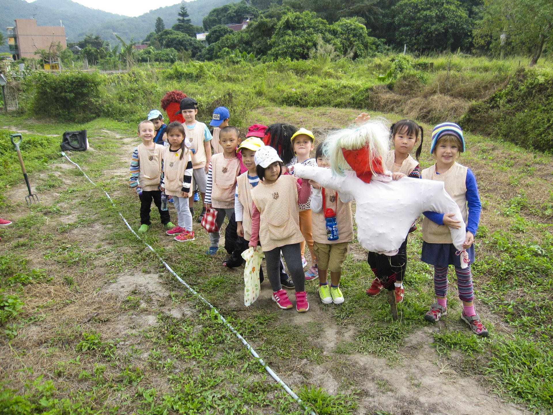 Making a scarecrow to protect seed beds is part of the hands-on fun for children at Dragontail Farm near Mui Wo.
