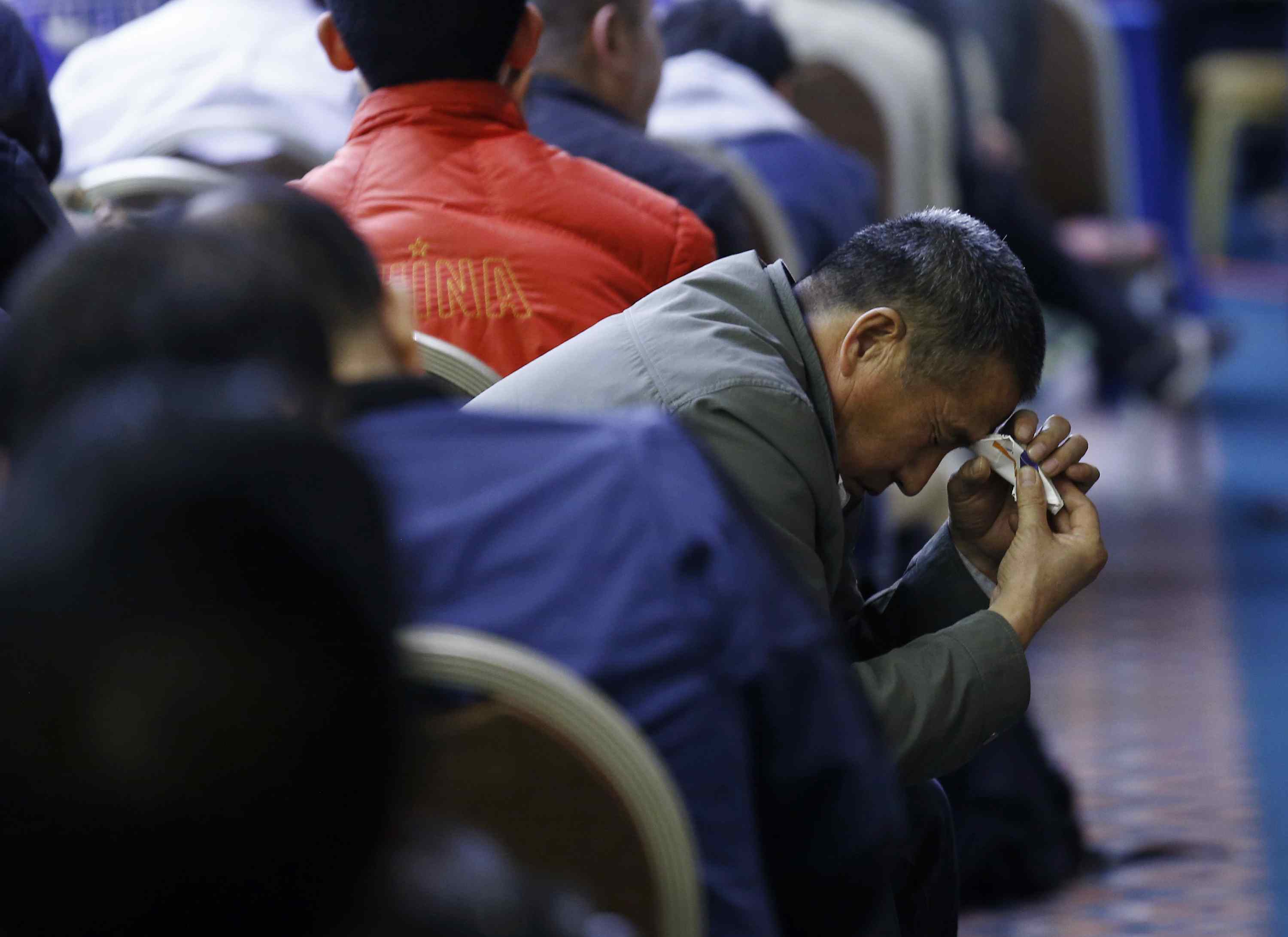 A family member of a passenger onboard the missing Malaysia Airlines MH370 cries at a briefing from Malaysian government in Beijing. Photo: Reuters