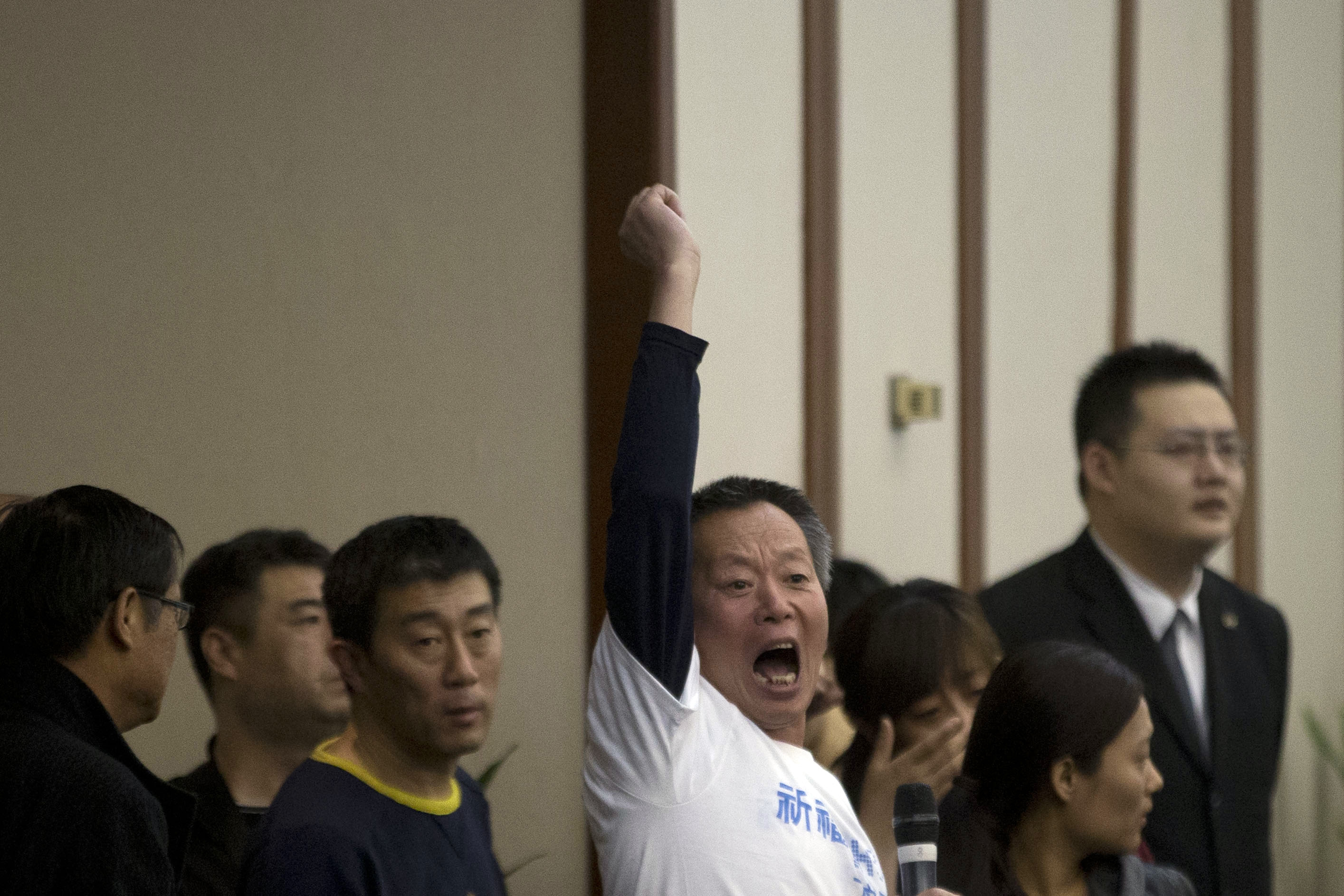 A relative of Chinese passengers aboard the missing Malaysia Airlines, flight MH370, protests after Malaysian government representatives leave after a briefing in Beijing on Saturday. Photo: AP