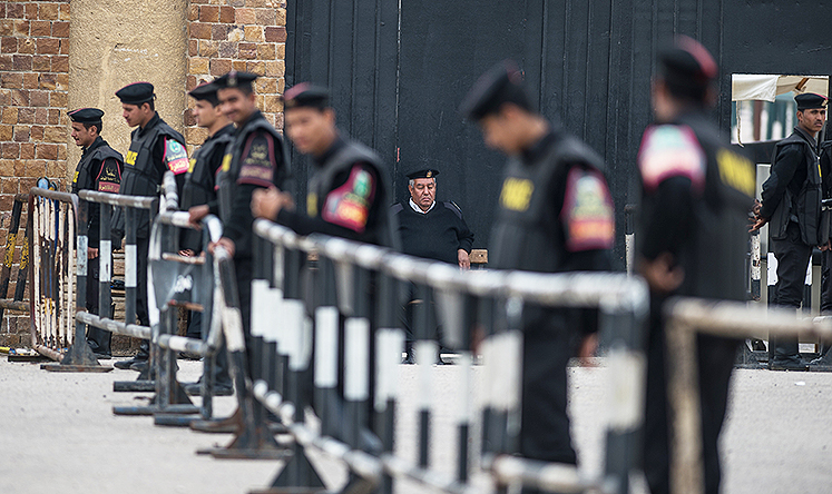 Policemen stand guard outside Cairo Police Academy where former Egyptian president Mohammed Mursi and other defendants await trial. Photo: Xinhua
