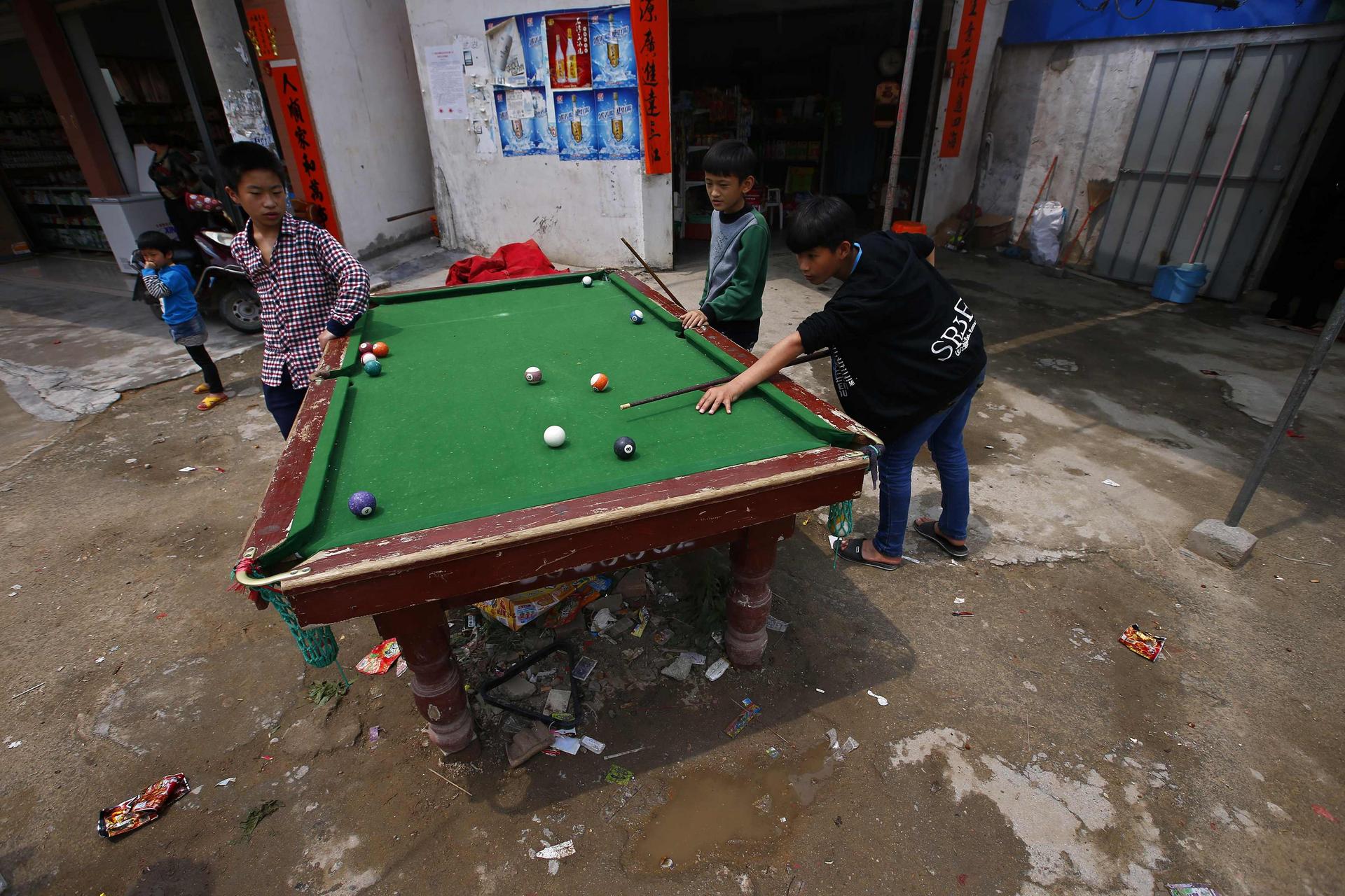 Children play pool in Wukan village on Sunday. Photo: Reuters