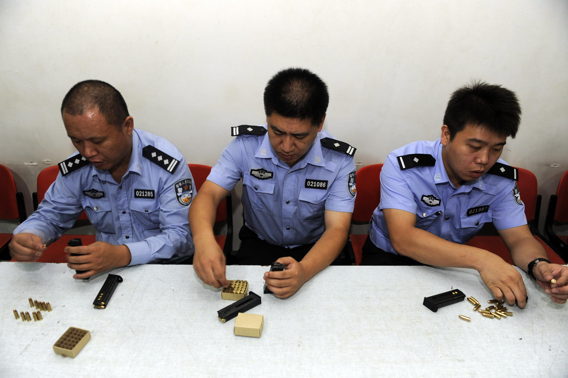 Police officers in Beijing receive training on how to load ammunition and handle their guns. Photo: AFP