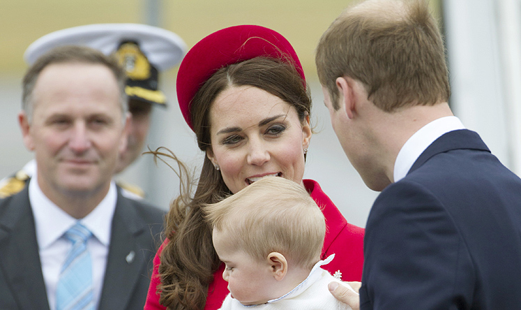 Prime Minister John Key (left) watches as Britain's Prince William, wife Catherine, and son Prince George arrive for their visit to New Zealand. Photo: AP