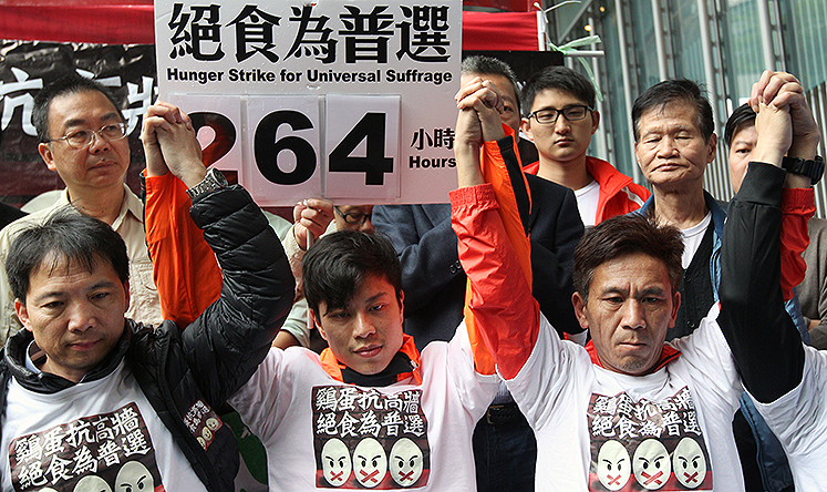 Protestors hold a hunger strike demanding universal suffrage outside the HSBC headquarters in Central. Photo: May Tse