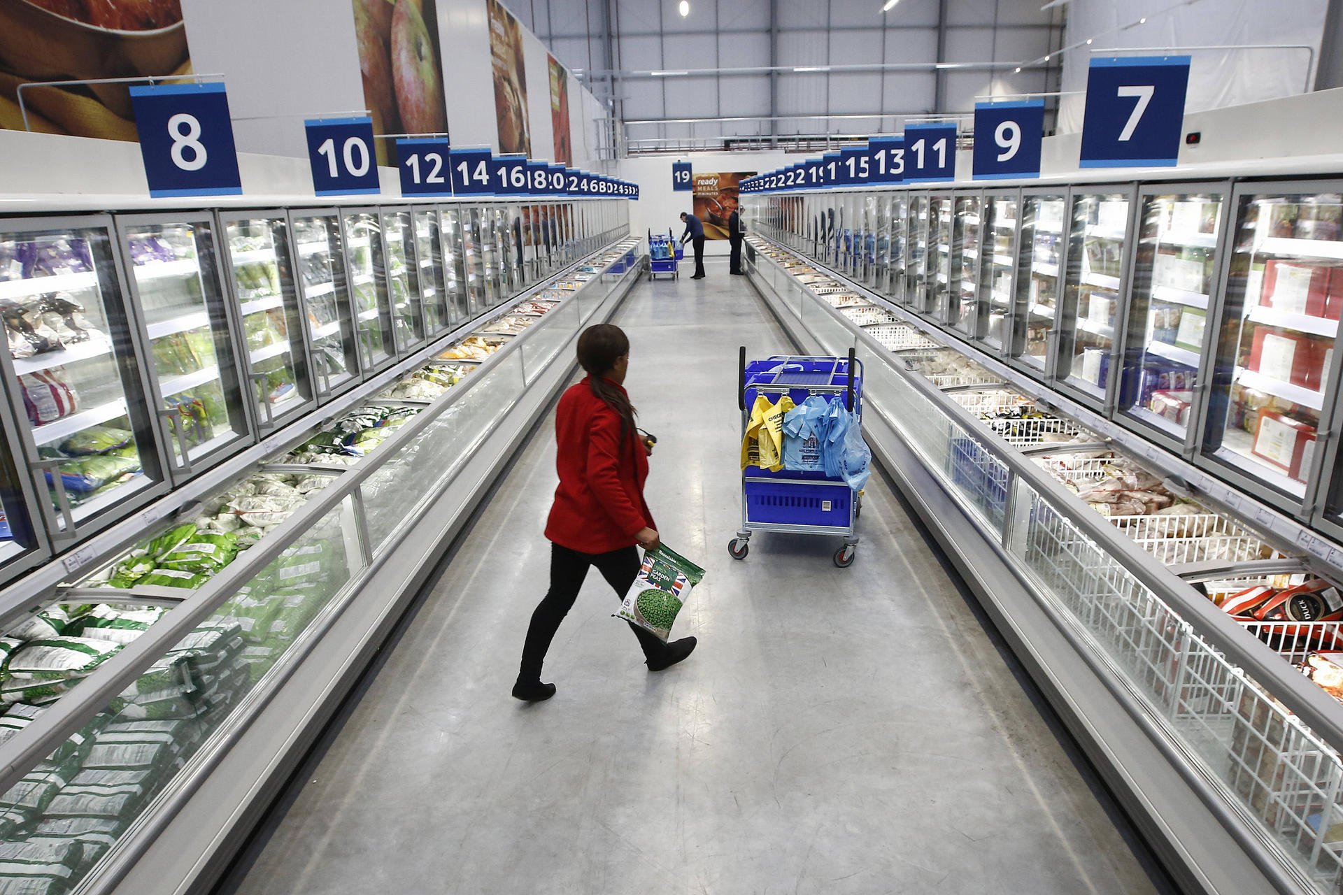 An employee collects customer orders at a Tesco online distribution centre. The retailer is losing out to budget chains. Photo: Bloomberg
