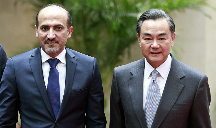 China's Foreign Minister Wang Yi with the head of the Syrian National Coalition Ahmad Jarba 