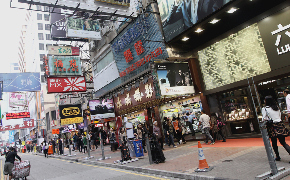 Sai Yeung Choi Street in Mong Kok. The street has become a de facto "shared space" in which pedestrians and vehicles mix.