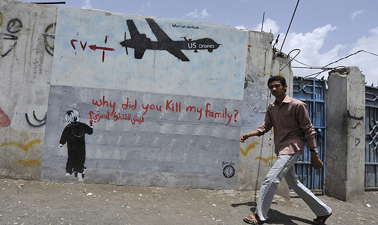 A Yemeni man walks near a graffiti protesting against US drone operations, in Sanaa earlier this month. Photo: EPA