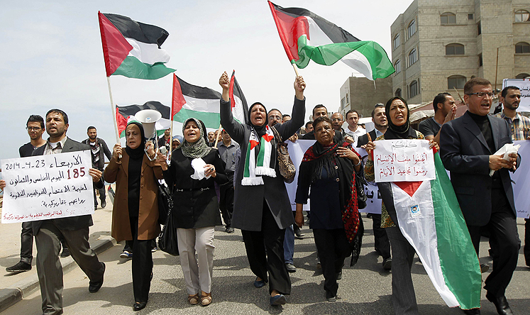 Palestinian demonstrate in support of a new attempt to reconcile the militant Islamist movement Hamas and its PLO rivals in Gaza City on Wednesday. Photo: AFP