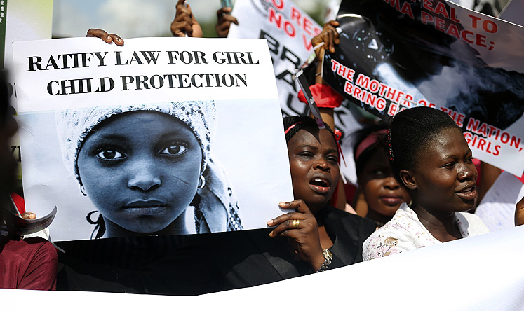 Nigerian Women holding signs take part in a protest demanding the release of abducted schoolgirls. Photo: Reuters