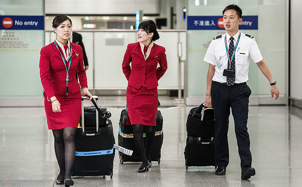 Cathay Pacific flight attendants want the airline to redesign their uniforms because they are too revealing and may provoke sexual harassment. Photo: AFP
