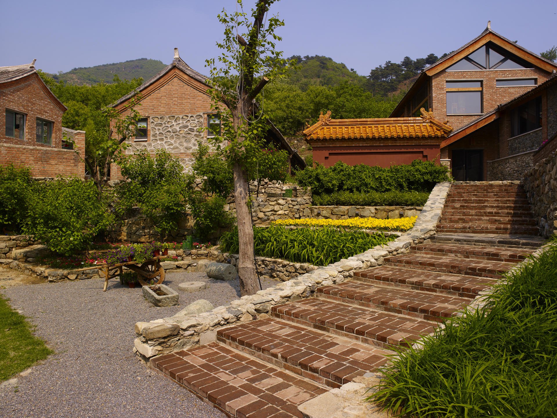 Ironstone, in Beigou village near Beijing, consists of several farmhouses and a new wing linked by an underground gallery. The 800 square metre interior features a large stone-and-granite fireplace and makes liberal use of wood to give the space visual warmth.