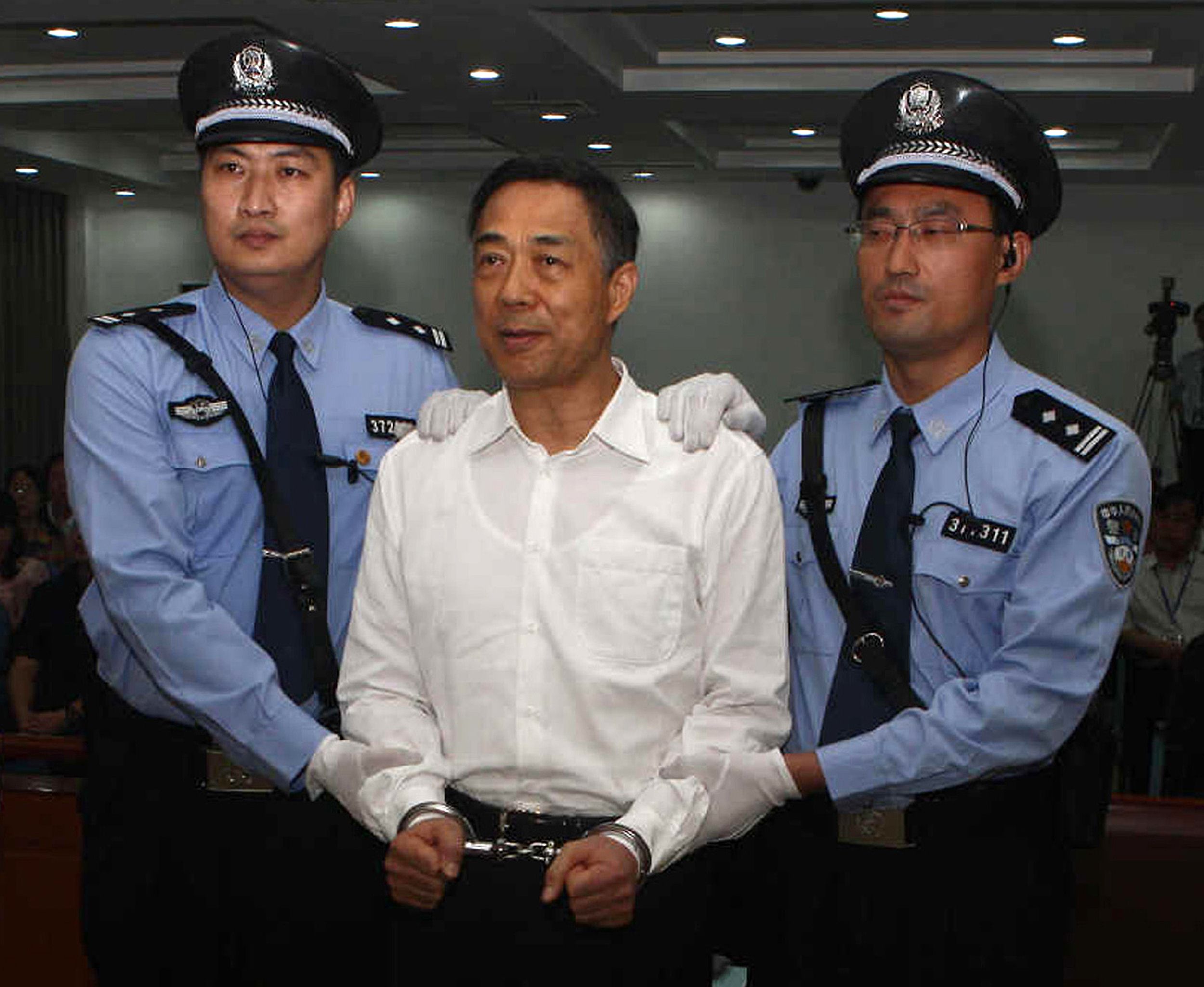 Former Chongqing Communist Party boss Bo Xilai is flanked by police at his trial, the most sensational seen on the mainland for decades. Photo: AFP 