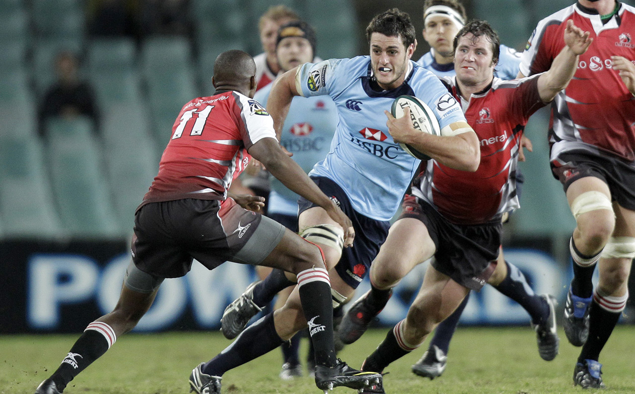Dave Dennis, pictured here leading the charge for the Waratahs, scored a late captain's try to help his team to a 33-17 victory over the Waikato Chiefs on Saturday. Photo: AP