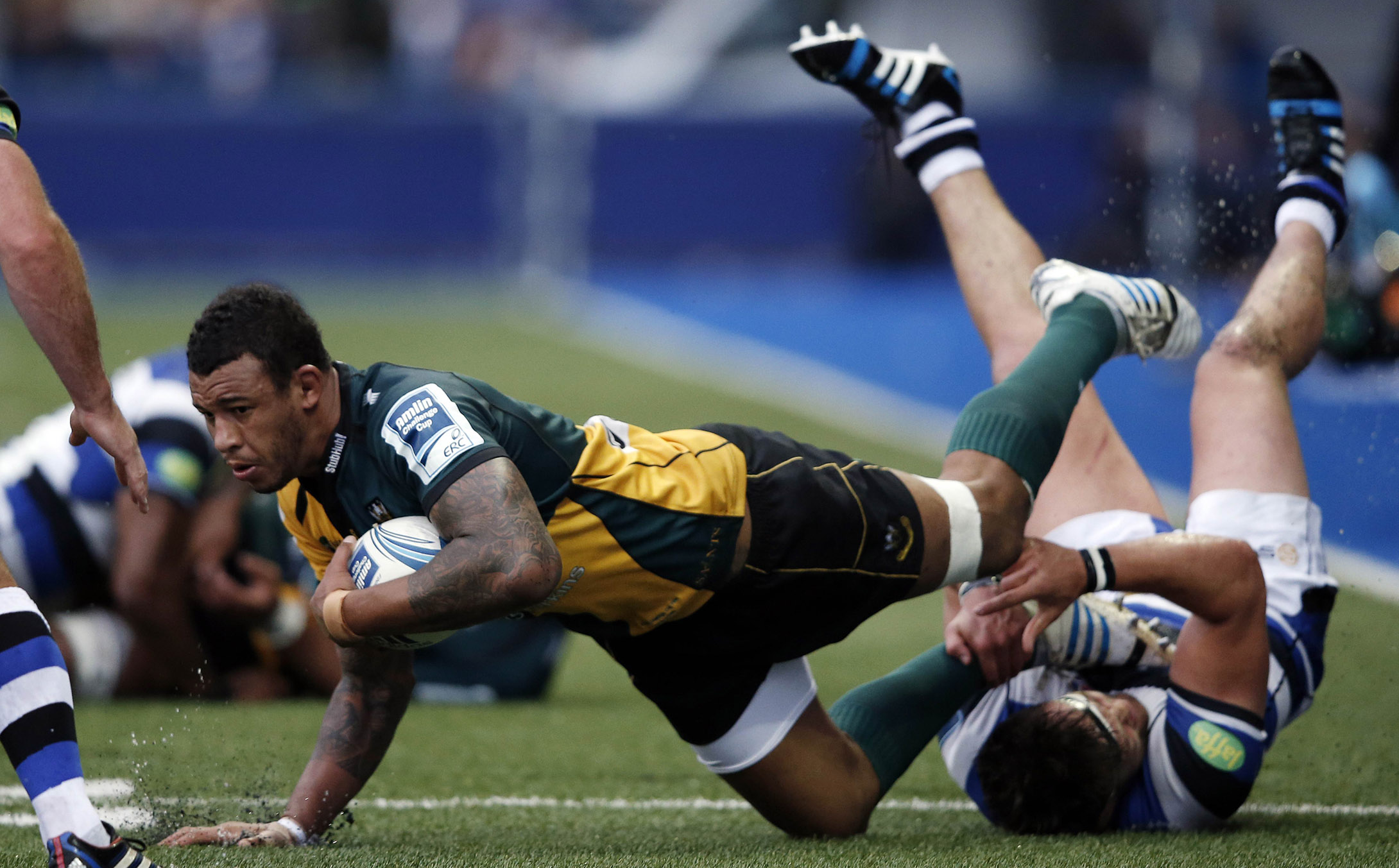 Northhampton lock Courtney Lawes is tackled by Bath hooker Tom Dunn during last week’s European Challenge Cup final. On Saturday, Saints became English champions for the first time when they beat Saracens 24-20 at Twickenham. Photo: AFP