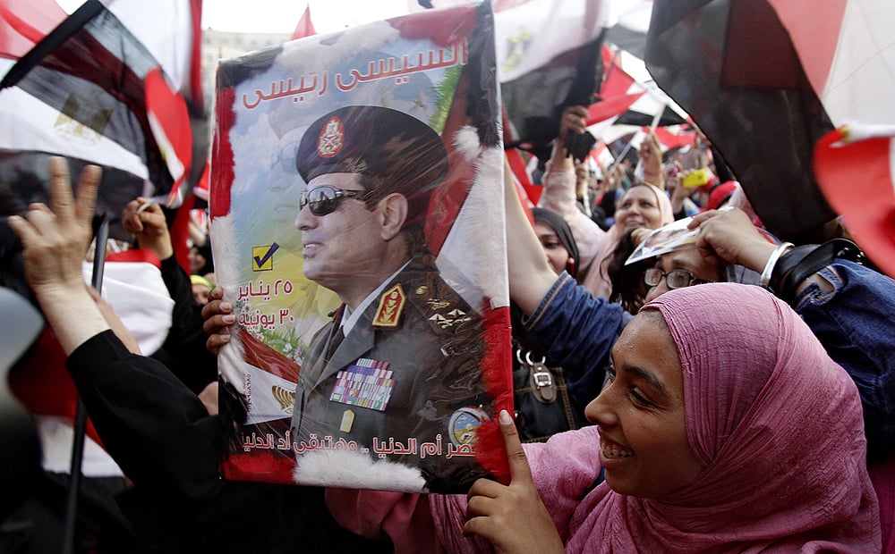 A woman holds a poster of Abdel- Fattah el-Sisi  at Tahrir Square in Cairo on Tuesday. Photo: Xinhua