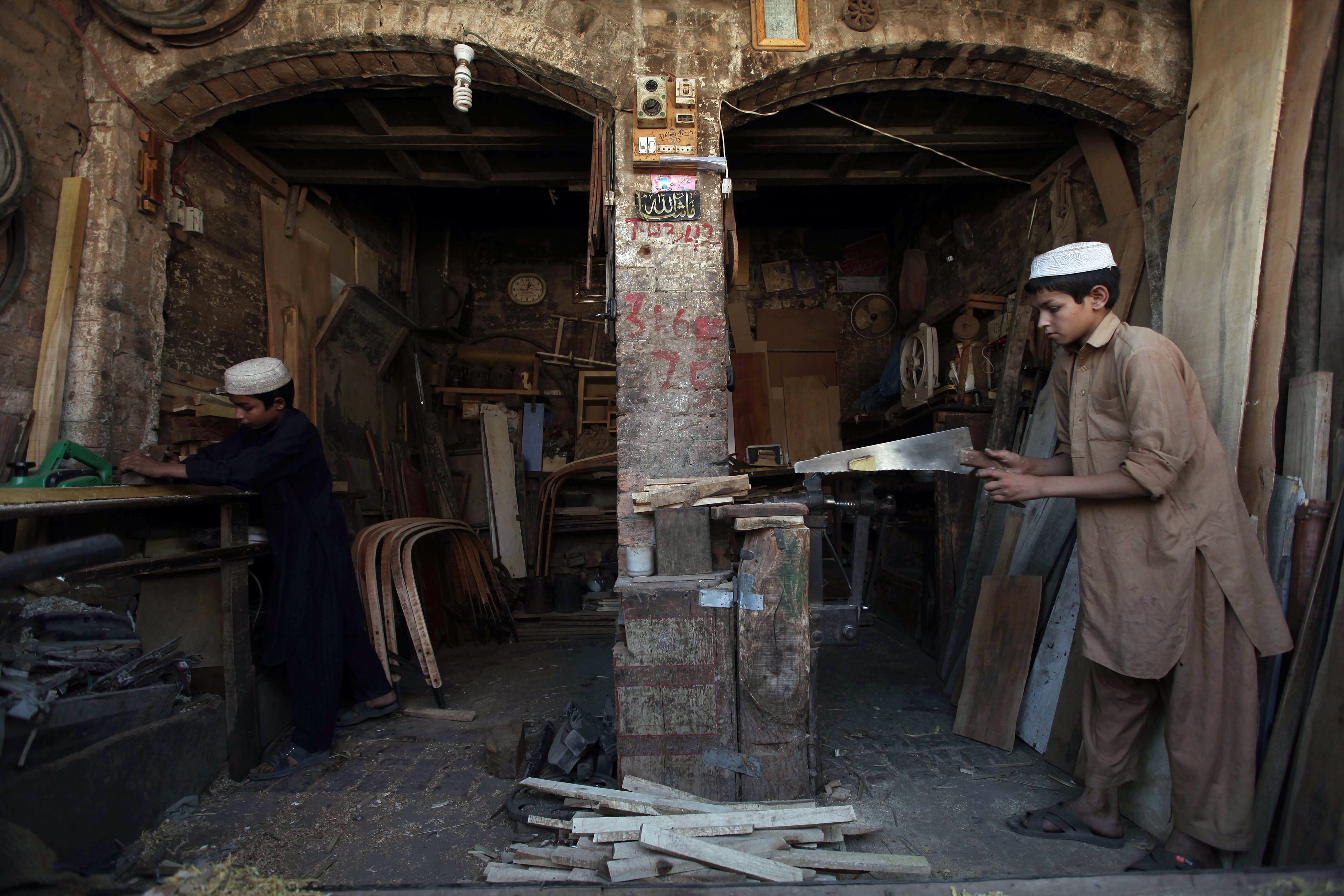 Young boys work as carpenters at a work shop in Peshawar, Pakistan. Photo: EPA