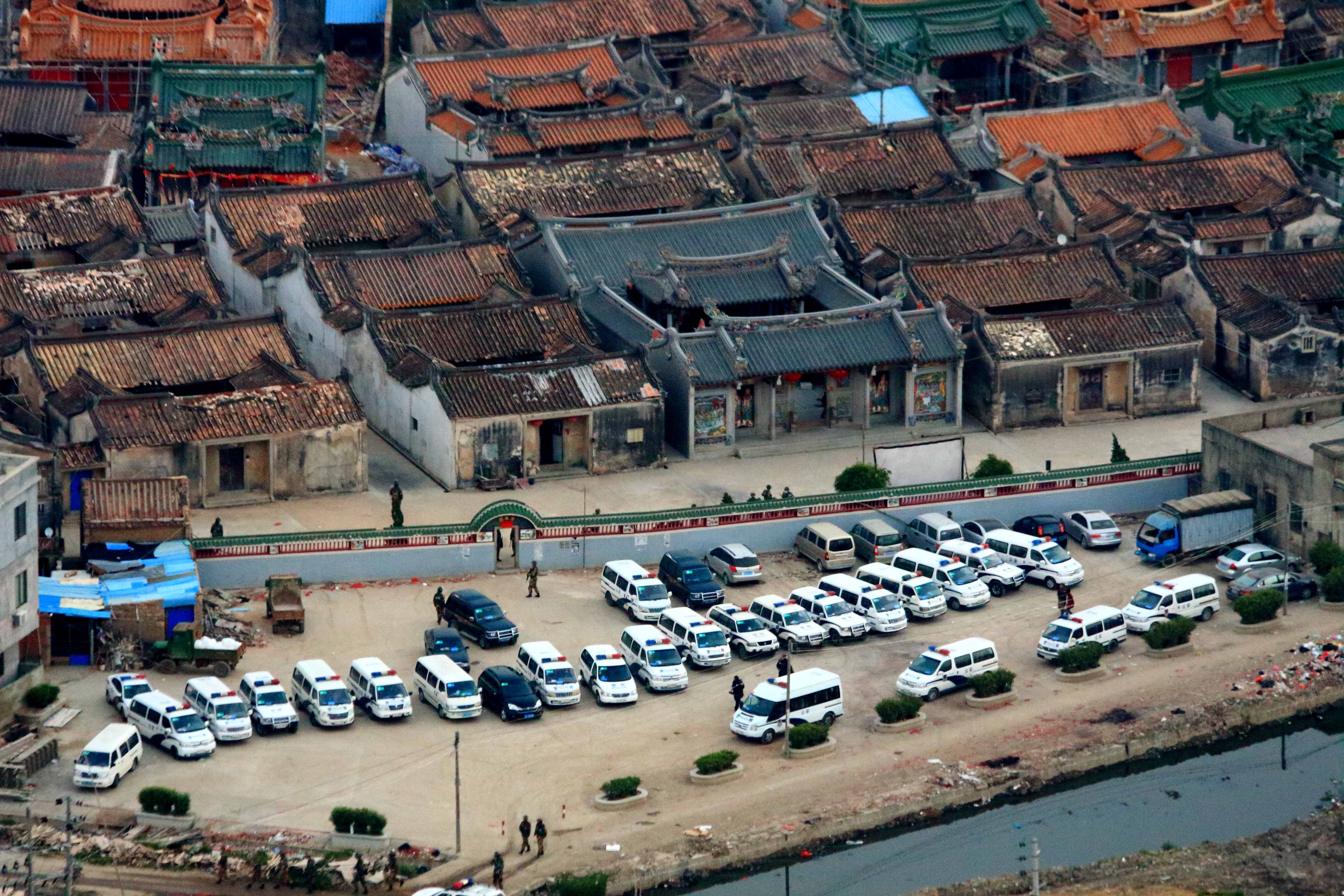 Police cars were lined up outside Boshe village, where a massive drug lab linked to numerous trafficking networks across the region was uncovered earlier this year. Photo: Xinhua