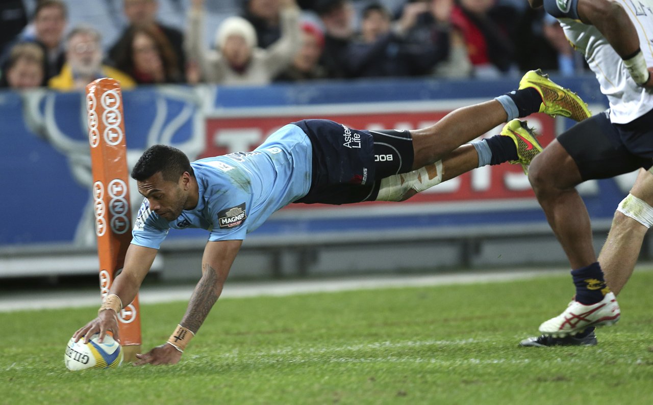 The Waratahs’ Alofa Alofa dives over to score a try in their 39-8 Super Rugby triumph over the Brumbies in Sydney. Photo: AP