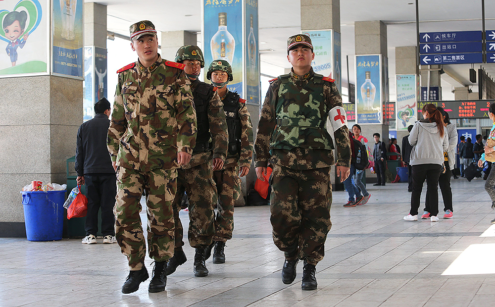 Paramilitary police patrol Kunming railway station in the wake of the attack. Photo: EPA