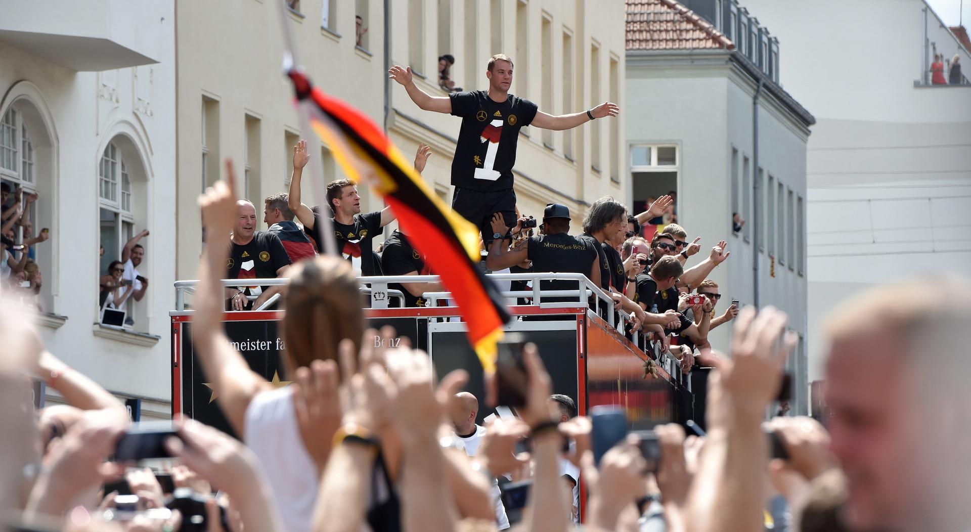 Germany goalkeeper Manuel Neuer gestures to fans during the drive along the so-called "Fan Meile" at Brandenburg Gate in Berlin on Tuesday. Photo: EPA 
