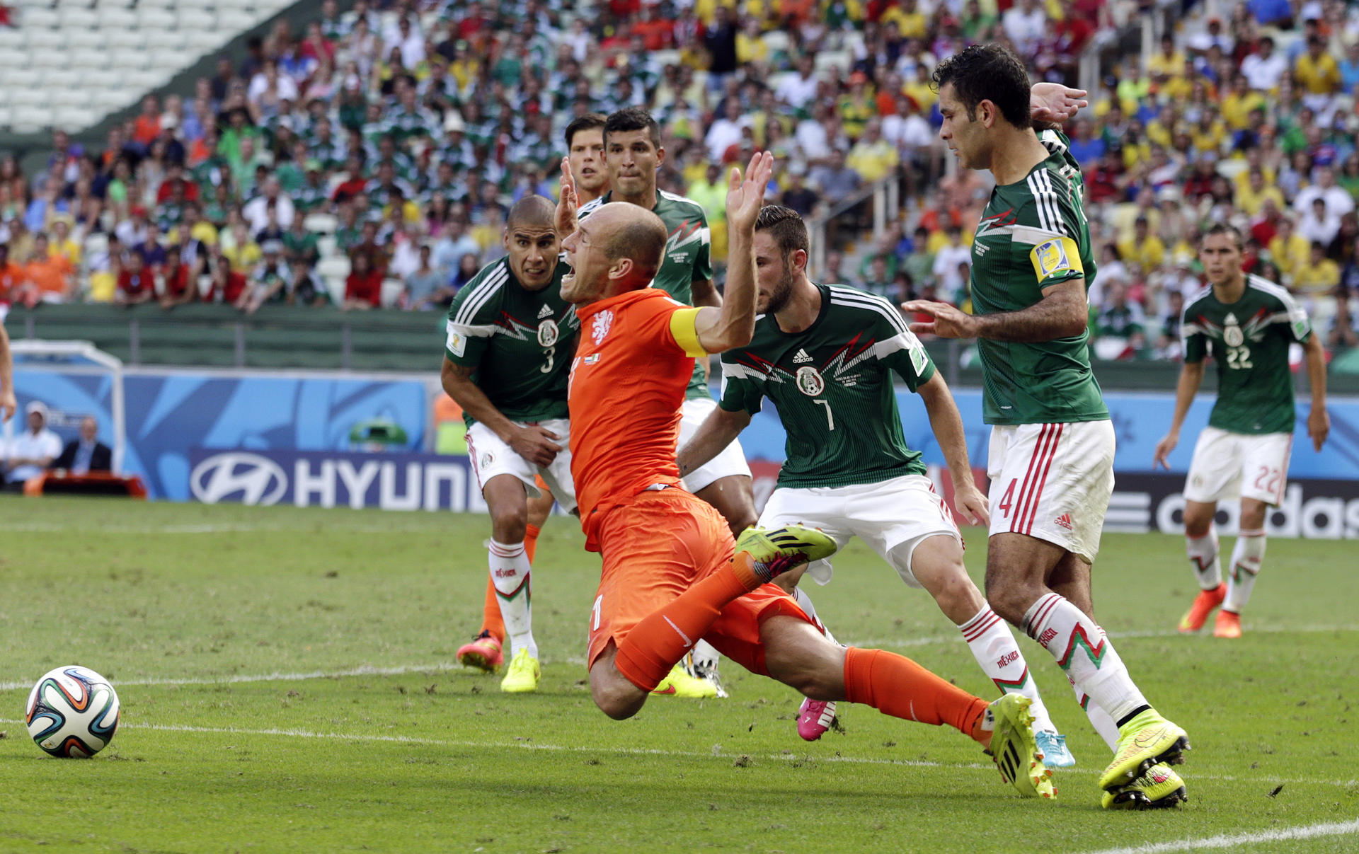 The Netherlands' Arjen Robben goes down to win a penalty against Mexico during their last 16 game, which the Dutch won 2-1. Photo: AP