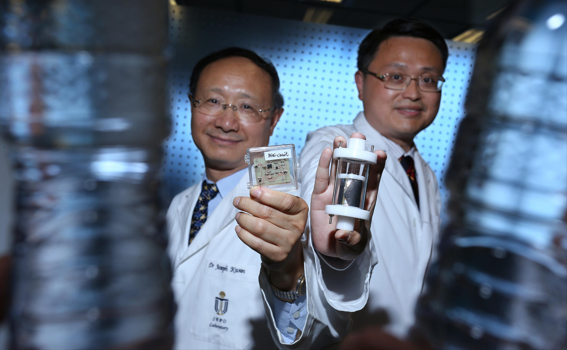 Professor Joseph Kwan (left) and Professor Yeung King-lun with prototypes of the water-disinfection device. Photo: Nora Tam