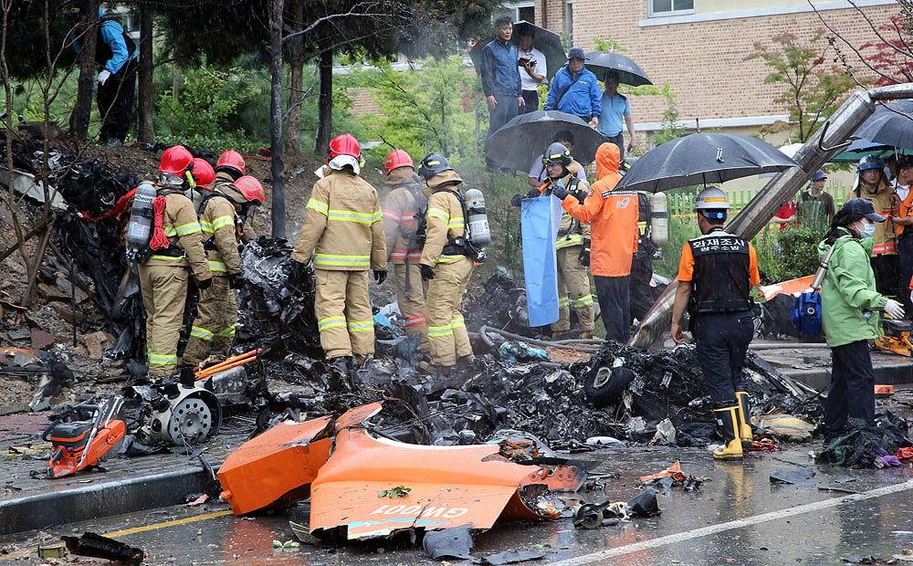 South Korean rescue services gather around the wreckage of a helicopter following a crash in the southern city of Gwangju on Thursday. Photo: AFP