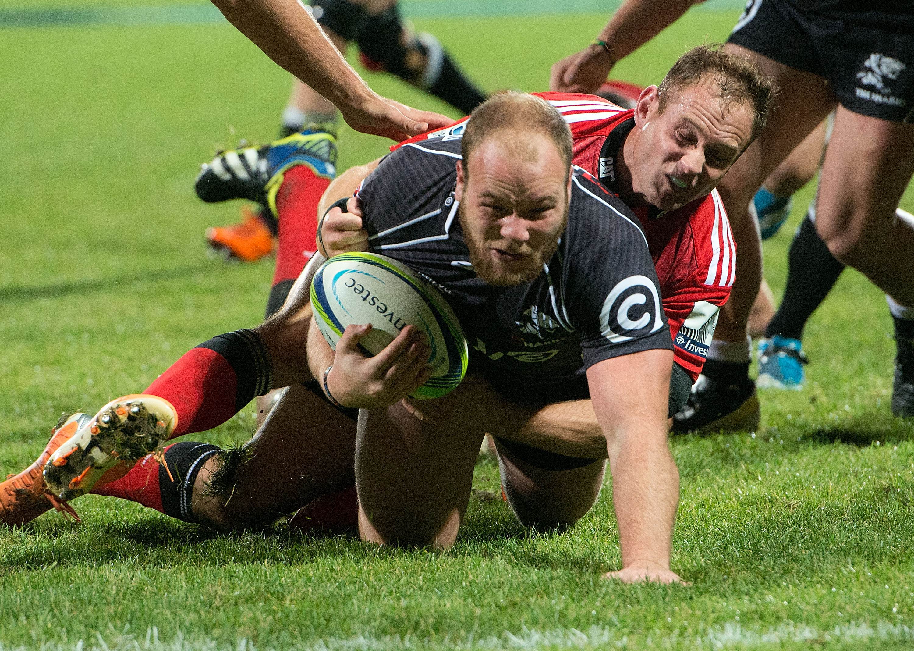 Kyle Cooper of the Sharks scores despite the attention of Crusaders' scrum-half Andy Ellis during their clash in May. The Crusaders turned in a poor performance on that occasion, but expect to turn the tide in their Super 15 semi-final. Photo: AFP