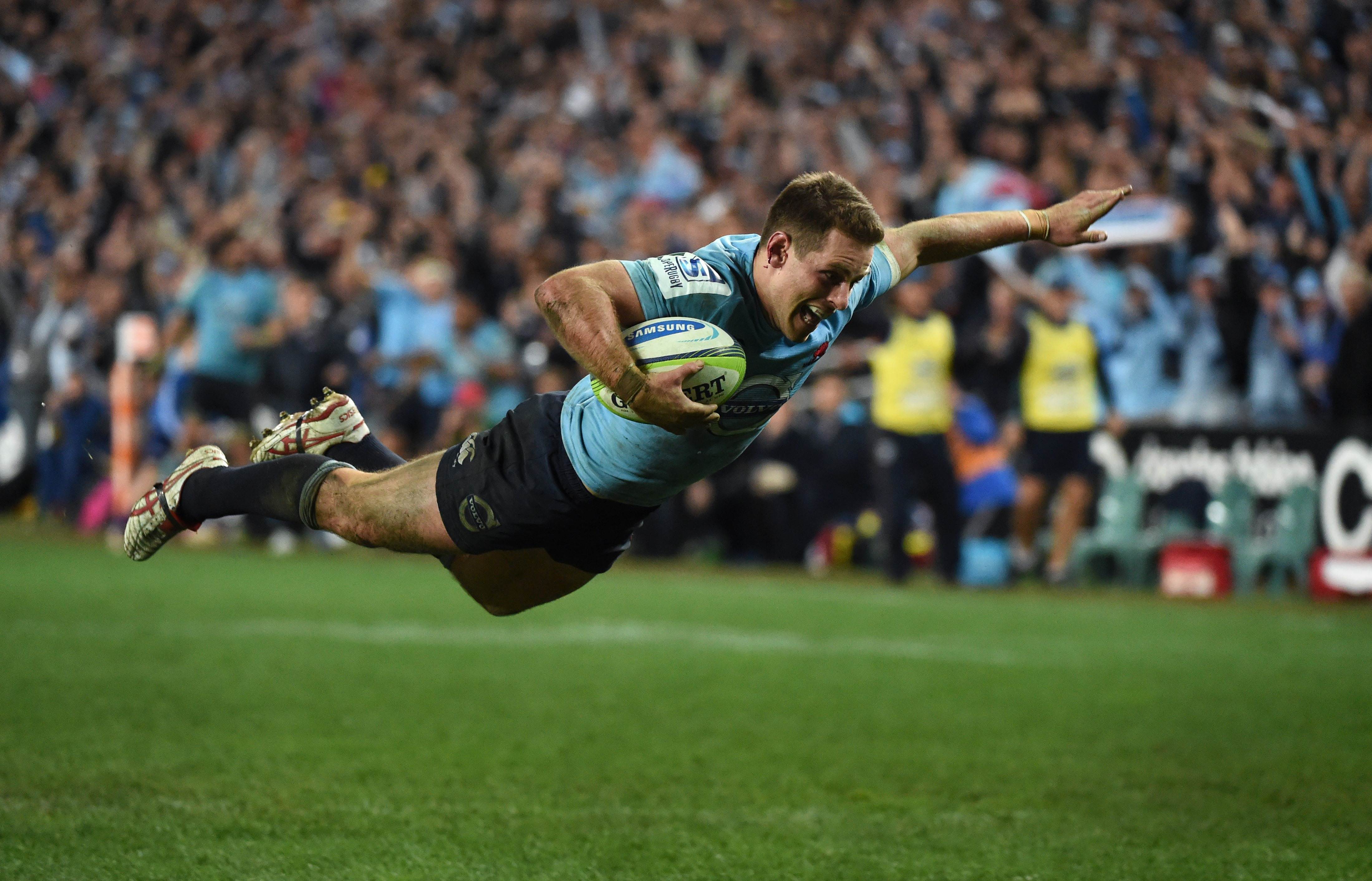 Waratahs fly-half Bernard Foley dives over to score against the Brumbies in their Super 15 semi-final in Sydney. Photo: AFP