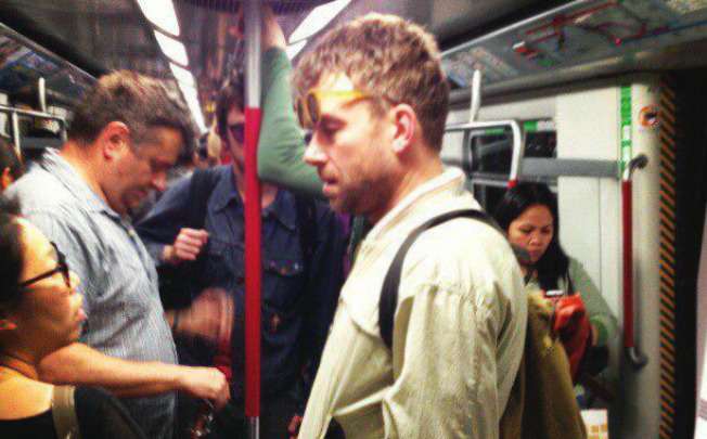 Damon Albarn is spotted on the MTR in 2013. Graham Coxon can be seen in the background in purple glasses. Photo: Marian Joy Hernandez