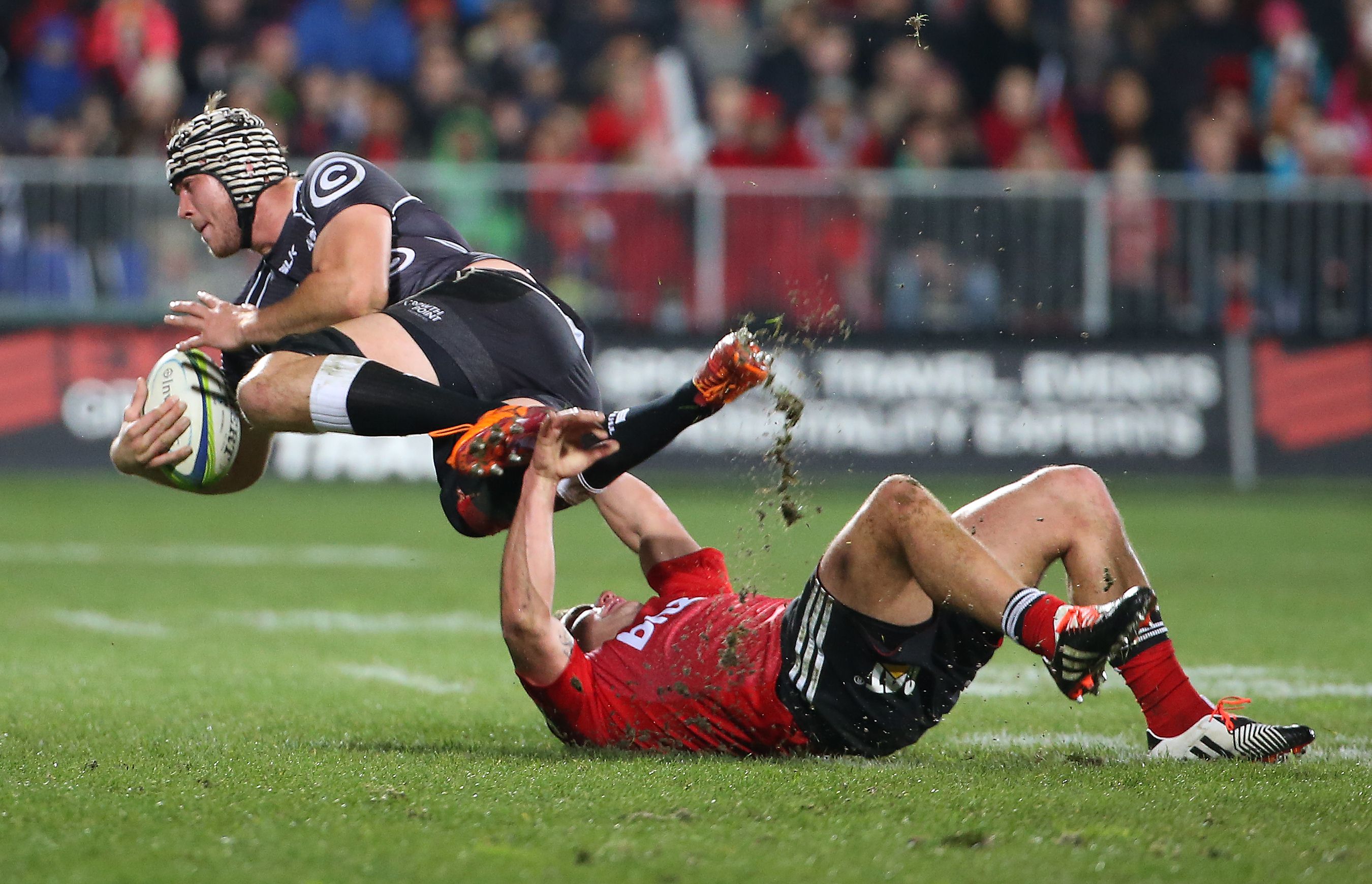 Kieron Fonotia (right) of the Crusaders tackles Stephan Lewies of the Coastal Sharks during their Super 15 semi-final. Photo: AFP