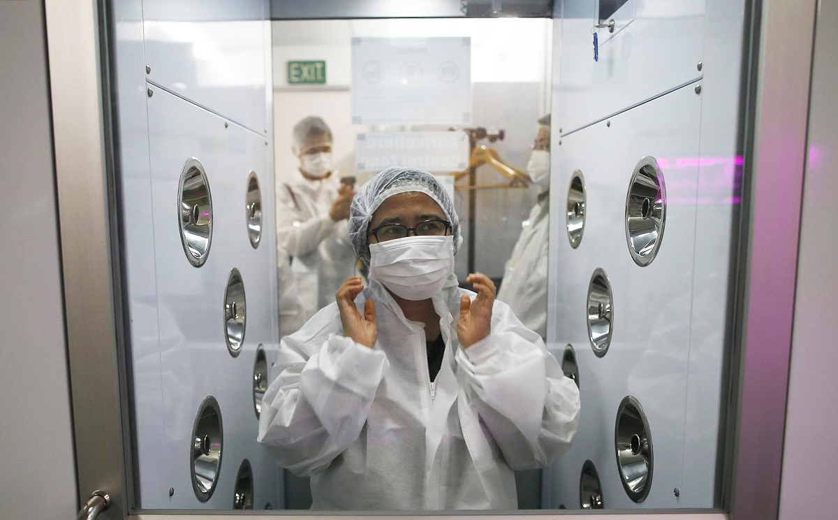 A visitor suits up before entering Panasonic's vegetable farm. Photo: Reuters
