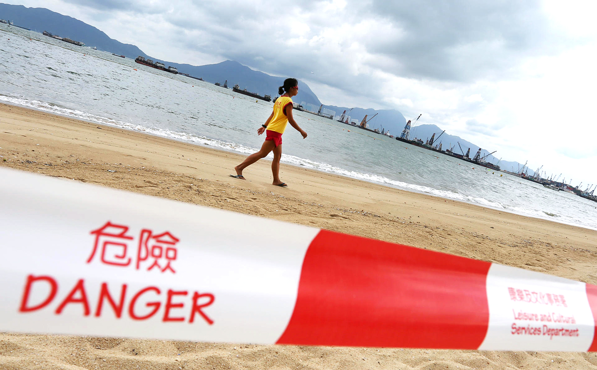A lifeguard patrols Butterfly Beach, one of several popular swimming spots that was closed after raw sewage was discharged. Photo: Nora Tam