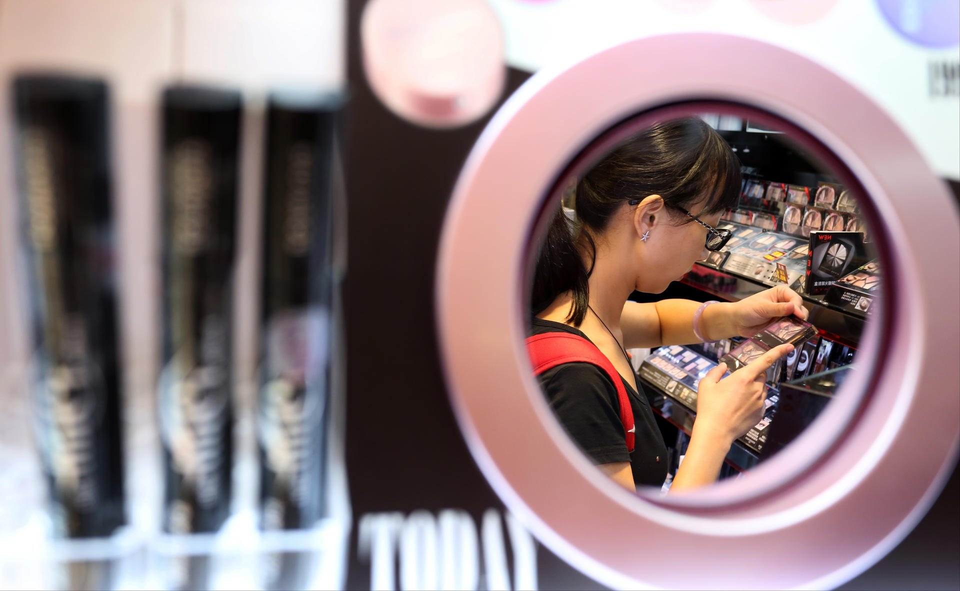 A young woman checks out some eye shadows at a Causeway Bay store yesterday, but packaging offers few clues as to whether a product was tested on animals. Photo: Nora Tam