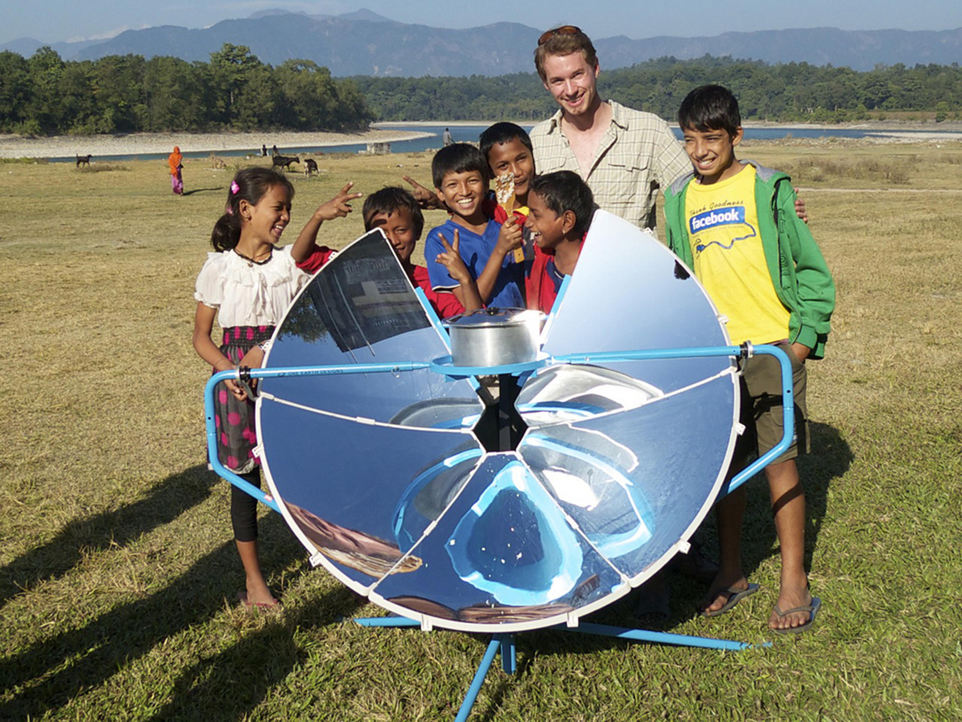 Scot Frank shows off the first version of his SolSource solar cooker in Nepal. Photo: One Earth Designs