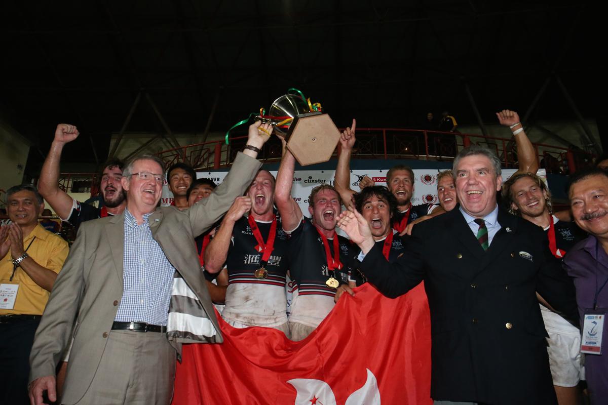 IRB chairman Bernard Lapasset and ARFU chief Trevor Gregory celebrate with Hong Kong's players. Photo: ARFU