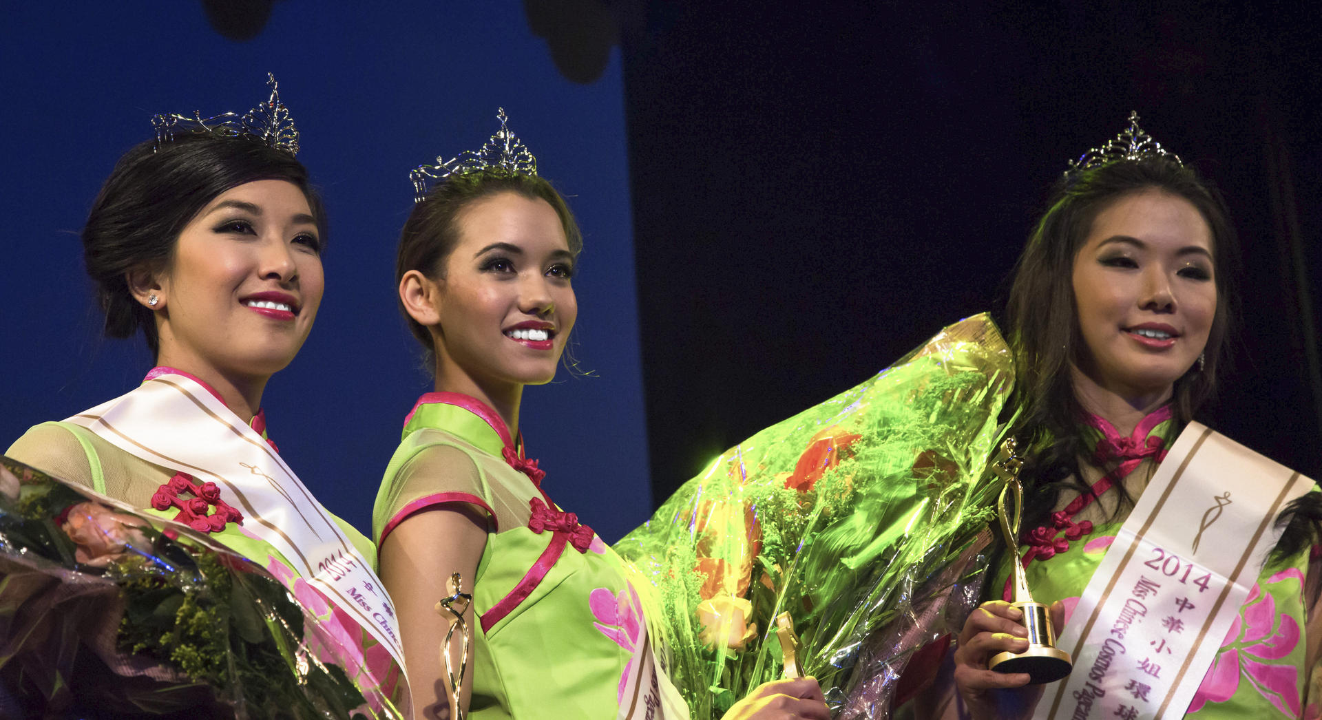 Kelly Murphy (centre), flanked by runners-up Michelle Lee (left) and Candice Hsu, is crowned South Africa's first Miss Chinese Cosmos, in Johannesburg. 